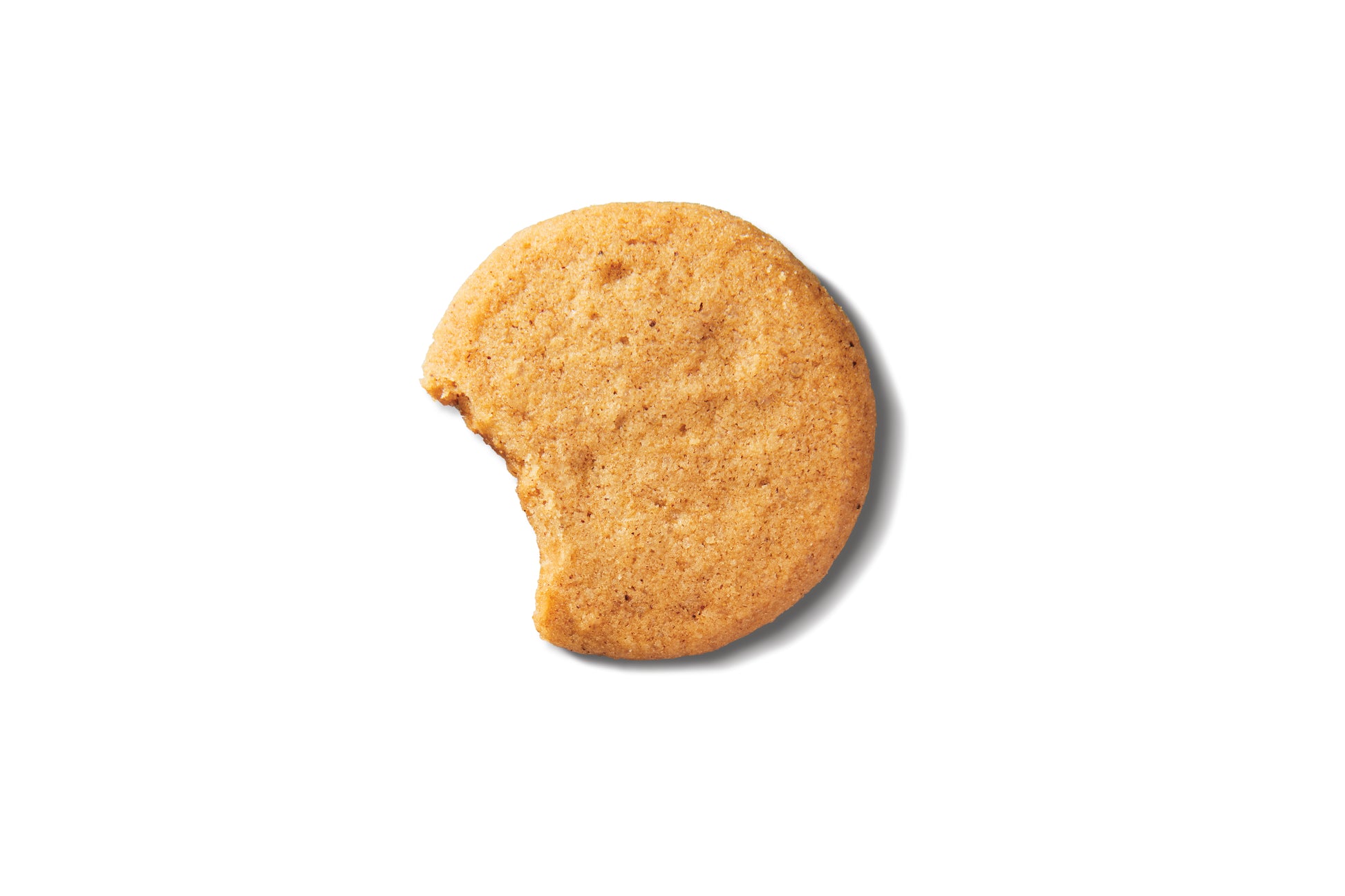half-eaten gingersnap cookie on a white background