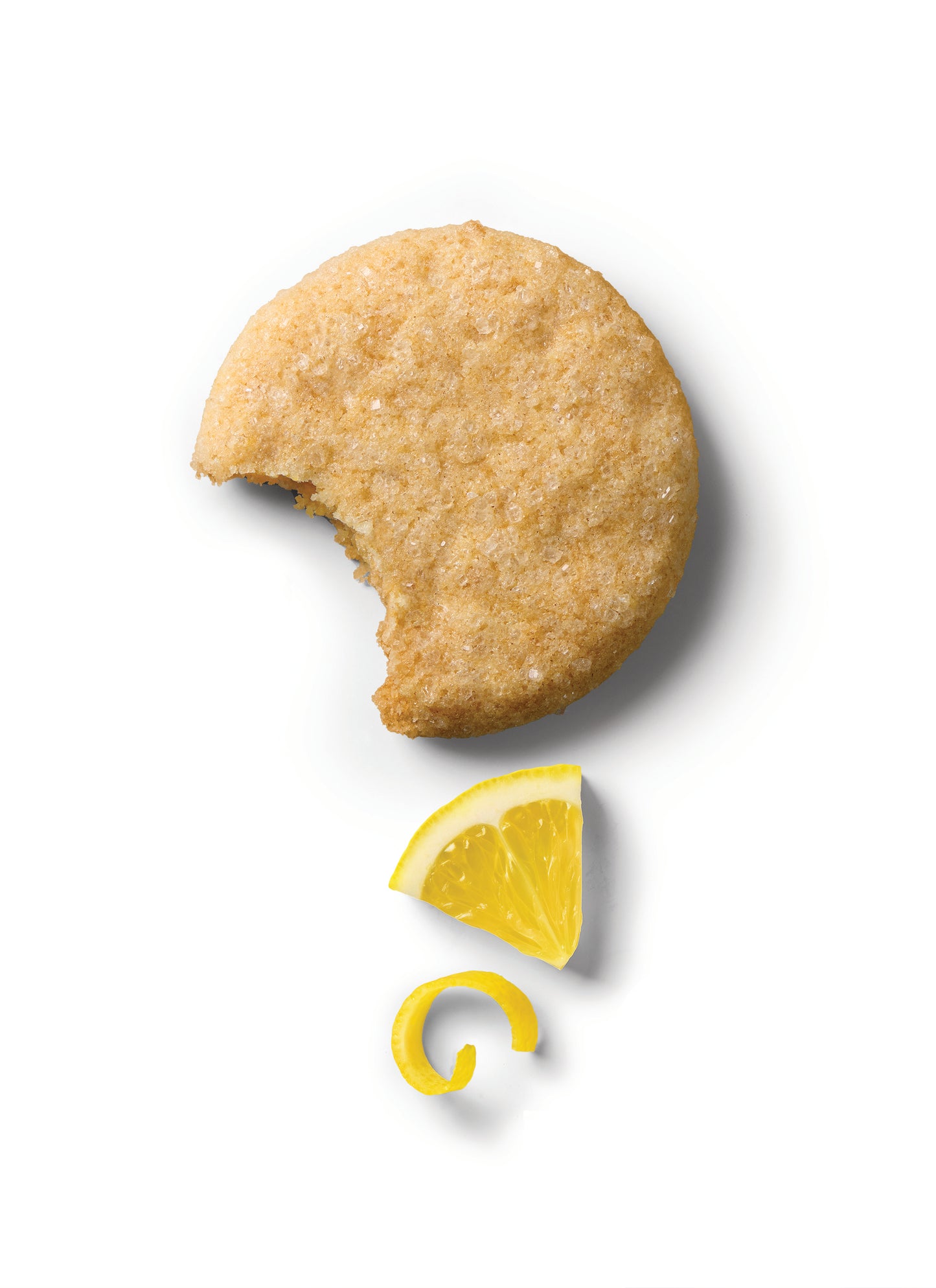 Lemon cookie with bite taken out and lemon slice on the side