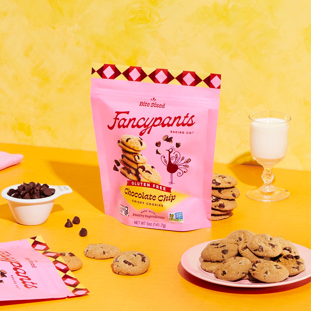 Fancypants gluten free chocolate chip cookies with cookies and milk on a yellow background