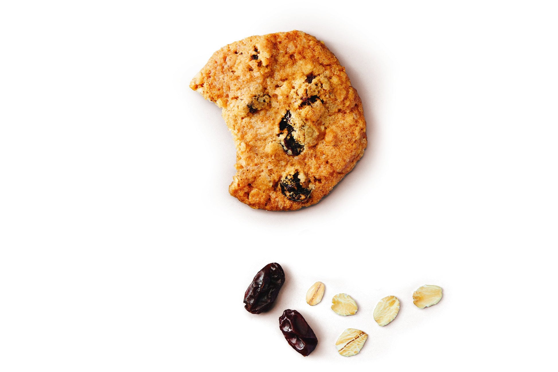 Thin crispy oatmeal raisin cookie with a bite taken, raisins and oat flakes beside it
