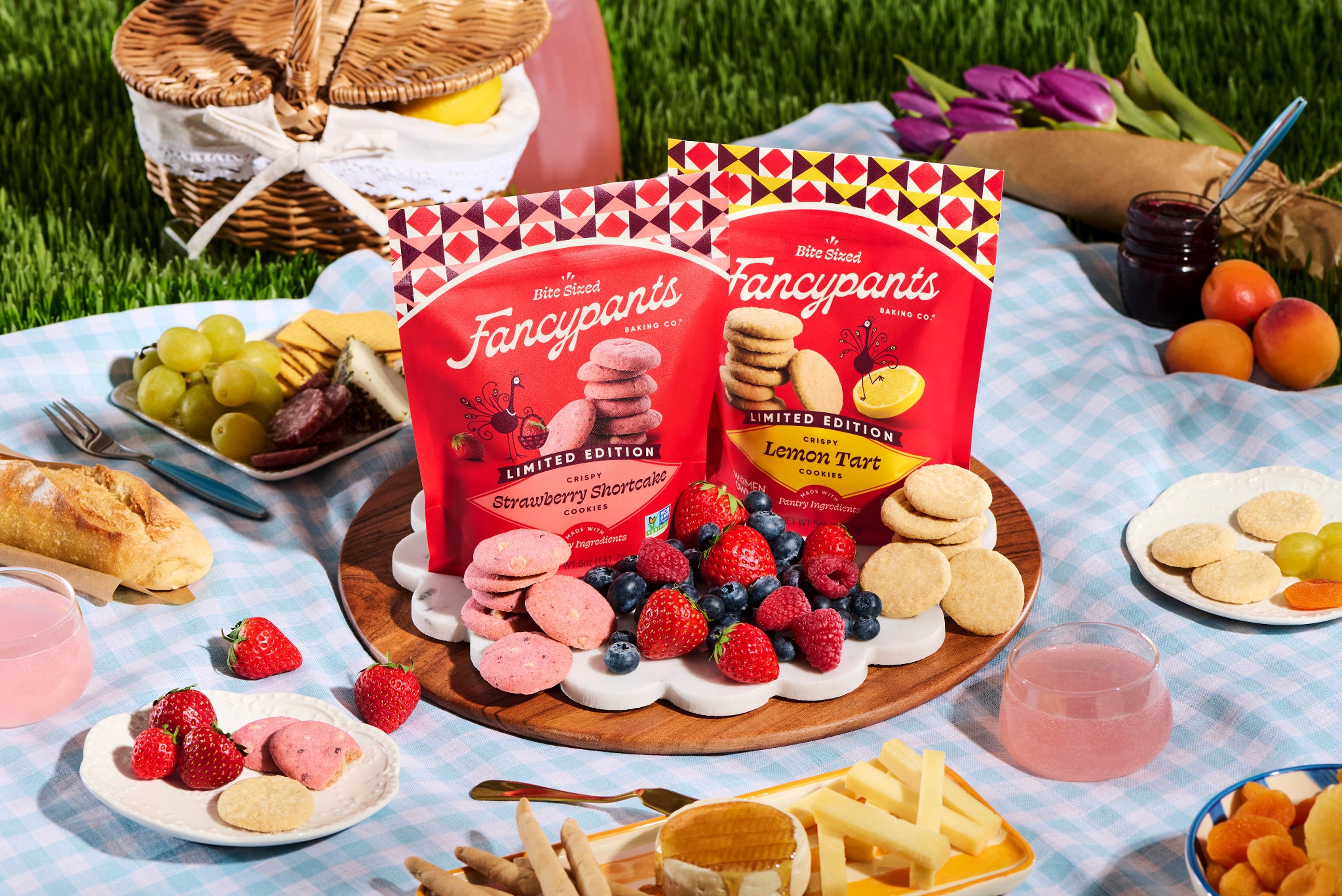 Fancypants Strawberry Shortcake and Lemon Tart cookies displayed at a spring picnic with fresh berries, citrus, and crisp buttery cookies